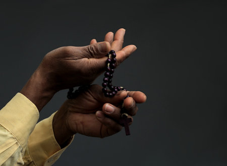 man praying to god with hands together Caribbean man praying with black background stock photos stock photoの写真素材