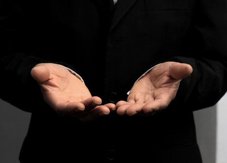 man praying to god with hands together Caribbean man praying with black background stock photos stock photoの写真素材
