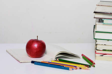 Back to school concept with books, apple and pencils on white background