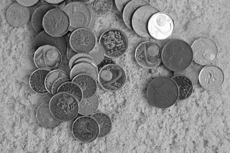Coins on the sand. Black and white photo.