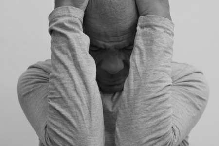 man praying to God with hands together stock photo