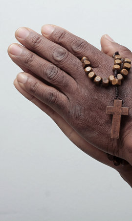 man praying to god with hands together Caribbean man praying with black background stock photos stock photoの写真素材