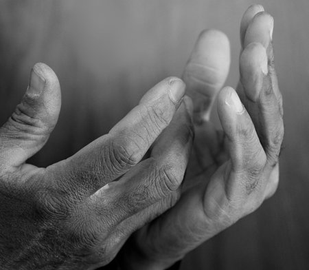 man praying to god with hands together Caribbean man praying with black background stock photos stock photoの写真素材