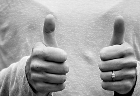 Two hands with thumbs up gesture in black and white. Close up.の写真素材