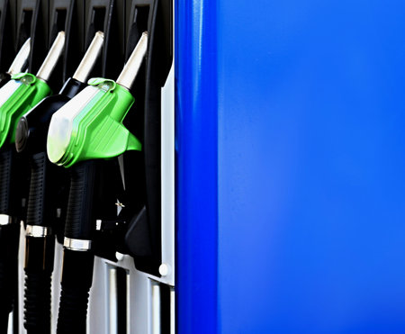 Close up of petrol pump nozzle on blue background. Gas station concept.の写真素材
