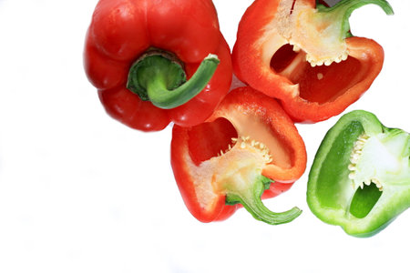 Red and green peppers isolated on white background, closeup of photoの写真素材
