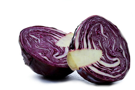 Red cabbage cut in half isolated on white background. Close up.の写真素材