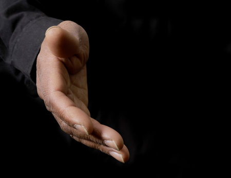 Hand of senior asian woman in black dress on black background.の写真素材