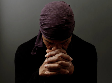 praying to god Caribbean man with people praying stock photo