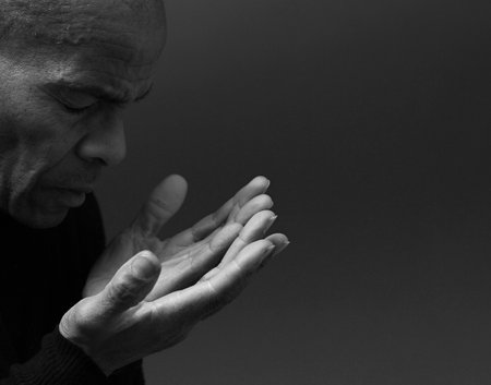 praying to god Caribbean man with people praying stock photoの写真素材