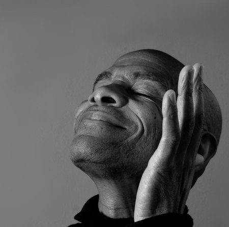 man praying to god with hands together Caribbean man praying with black background stock photos stock photoの写真素材