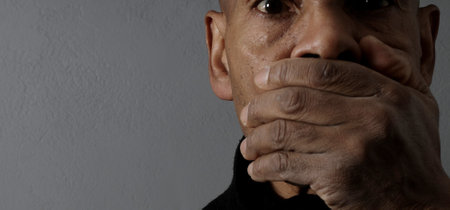 man praying to god with hands together Caribbean man praying with black background stock photos stock photoの写真素材