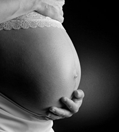 Pregnant woman with hands on her belly. Black and whiteの写真素材