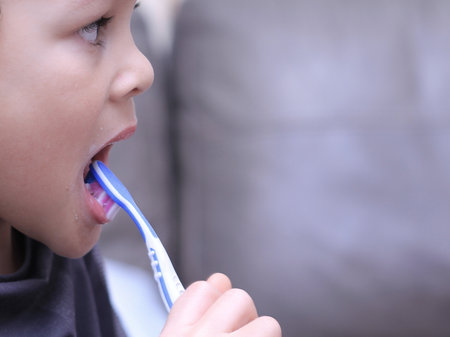 Little boy brushing his teeth with a toothbrush. Selective focus.の写真素材
