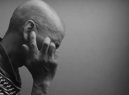 deaf man suffering from deafness and hearing loss on grey black background with people stock image stock photoの写真素材