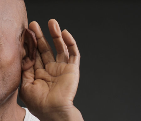deaf man suffering from deafness and hearing loss on grey black background with people stock image stock photoの写真素材