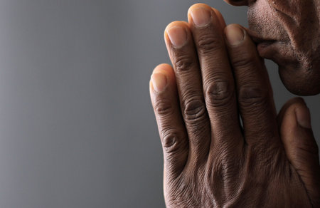 man praying to god with hands togetherの写真素材