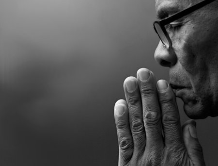 praying to god on gray black background with people stock image stock photoの写真素材