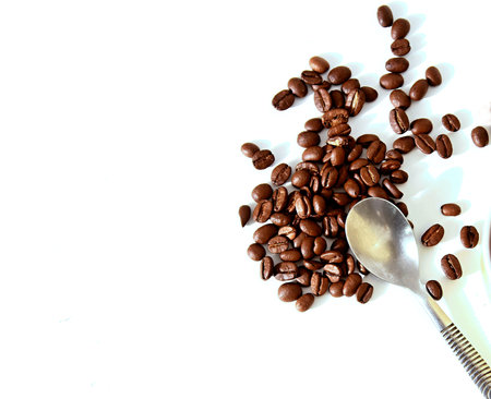 coffee beans on white background with spoon and cup of coffee.の写真素材