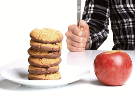 cookies and an apple on a plate on a white background.の写真素材