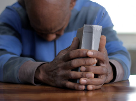 black man praying to god on gray background with people stock image stock photoの写真素材