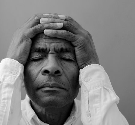 black man praying to god on gray background with people stock image stock photo