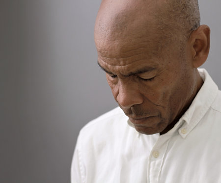 black man praying to god on gray background with people stock image stock photoの写真素材