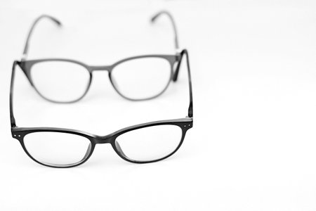 reading glasses on display on a table at an optician shop no people on white background stock image...
