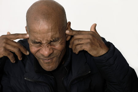 deafness suffering from hearing loss on grey black background with people stock image stock photoの写真素材