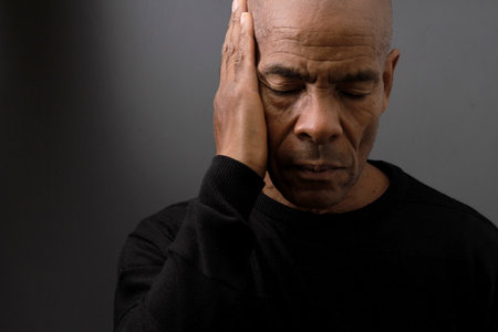 deafness suffering from hearing loss on grey black background with people stock image stock photoの写真素材