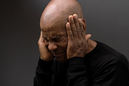 deafness suffering from hearing loss on grey black background with people stock image stock photoの写真素材