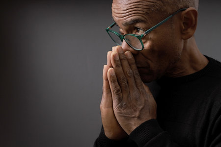 praying to god on gray black background with people stock image stock photoの写真素材