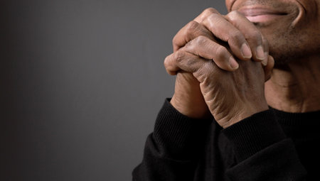 praying to god on gray black background with people stock image stock photoの写真素材