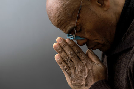 praying to god on gray black background with people stock image stock photo
