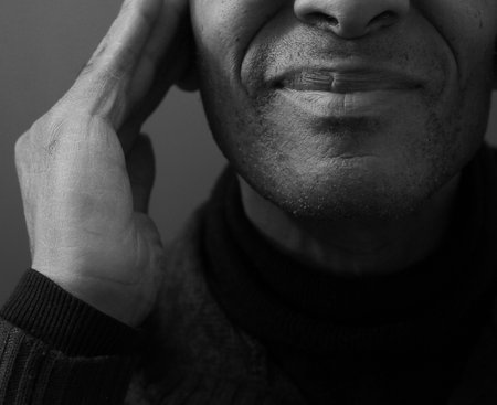 deafness suffering from hearing loss on grey black background with people stock image stock photoの写真素材