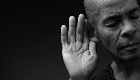 deafness suffering from hearing loss on grey black background with people stock image stock photoの写真素材