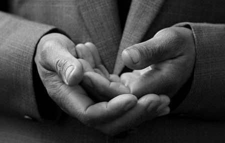 man praying with bible with grey black background with people stock image stock photoの写真素材