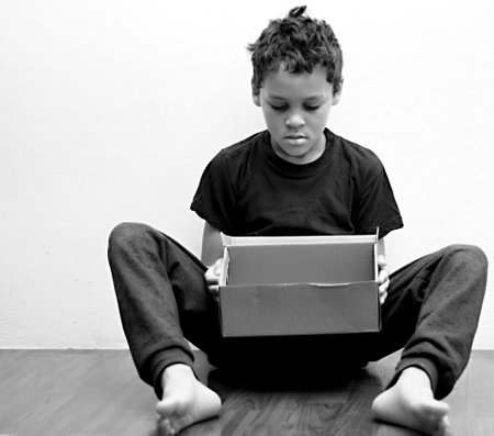boy praying in poverty on the floor stock image with no help crying alone and all by himself on white background stock photoの写真素材