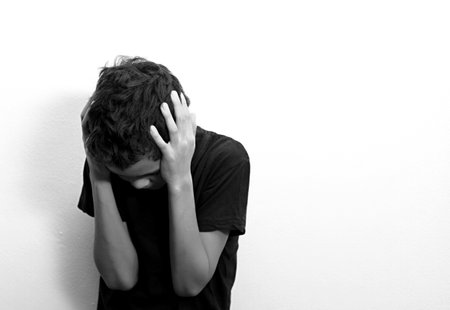 boy praying in poverty on the floor stock image with no help crying alone and all by himself on white background stock photoの写真素材