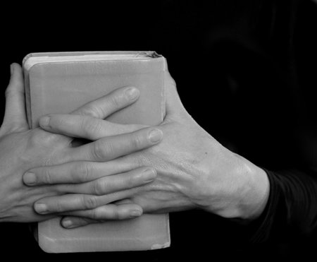 Book in the hands of a woman. Black and white.