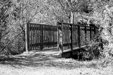 Small wooden bridge spanning a river.の写真素材