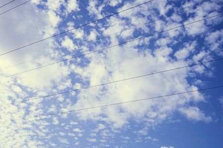 Electric cables and geometrical figures in the sky.の写真素材