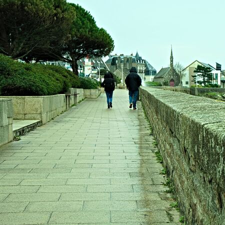 Couple walking side by side.