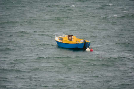 Small boat on the waves.の写真素材
