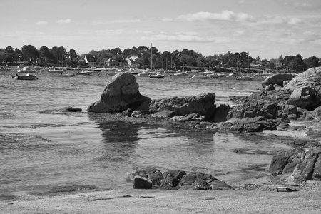 Rocks and boats at anchor.の写真素材