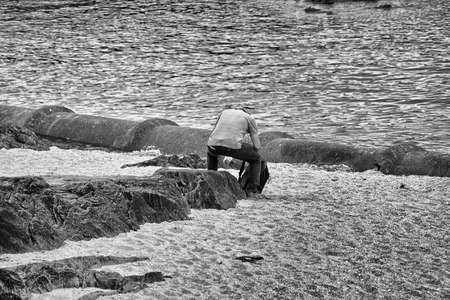 Man sitting on the rocks.の写真素材