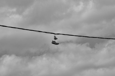 Shoes suspended on electric cables.の写真素材
