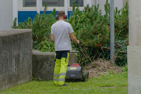 Worker mowing the lawn.の写真素材