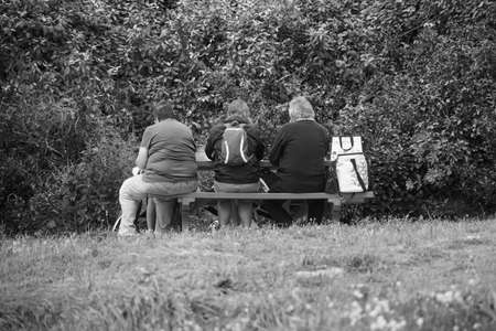 Three people on a bench.
