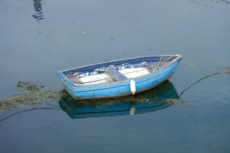 Boat and its reflection in the water.の写真素材
